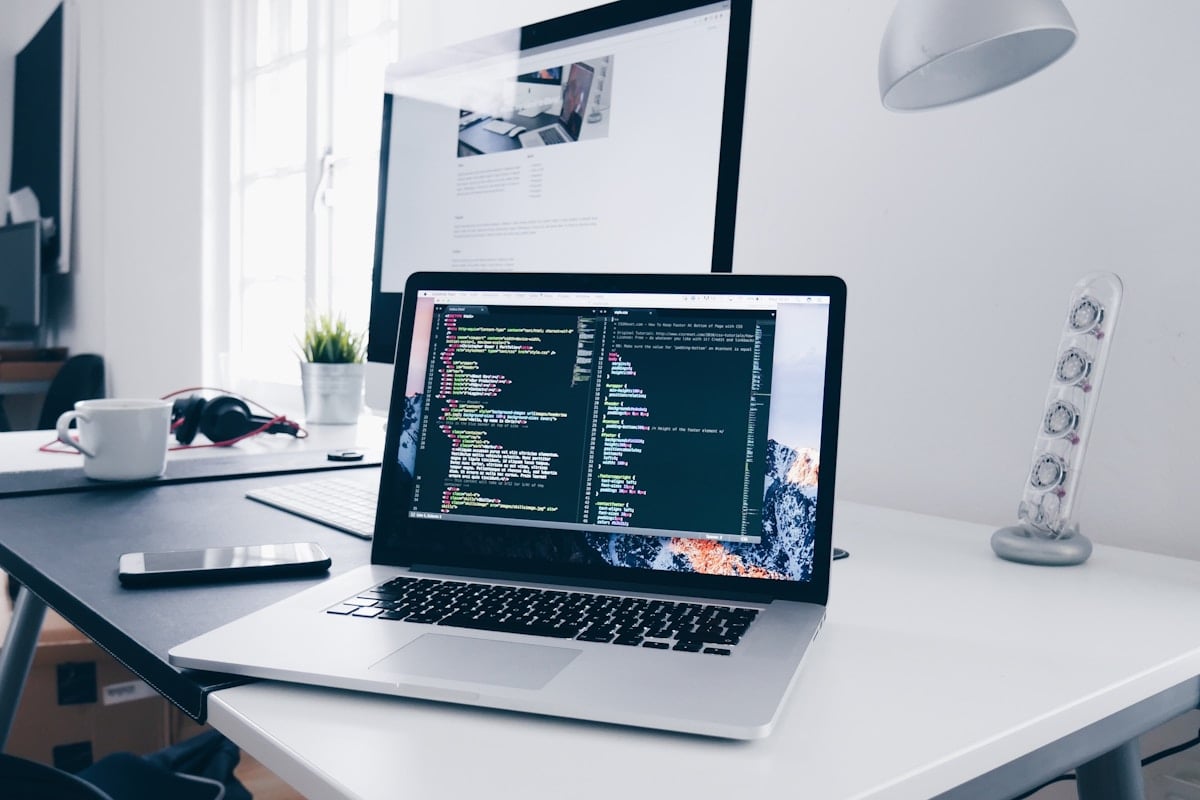 Modern web design workspace with laptop, design tools, and creative elements